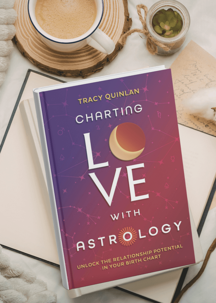 Book cover reading 'Charting Love with Astrology' by Tracy Quinlan, featuring a purple‑pink constellation background on a desk with a coffee mug and a small jar plant nearby