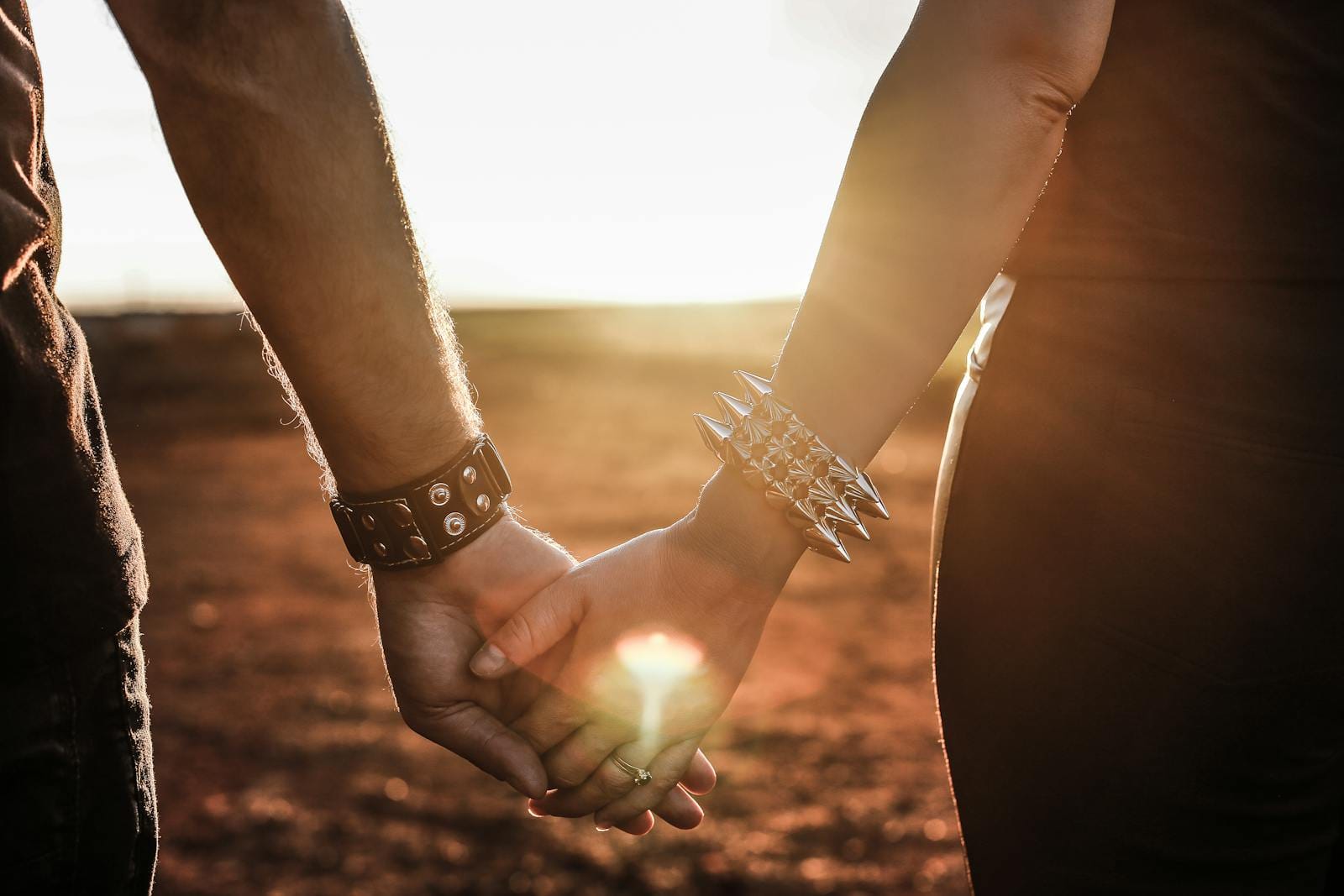 Couple holding hands at sunset - Tracy Quinlan A couple holding hands at sunset — reading love in the birth chart